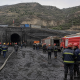 Realistic editorial image of rescue vehicles and mine workers outside a coal mine entrance after a gas explosion in Shanxi.