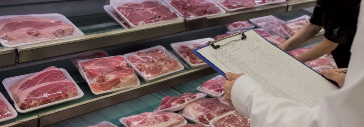 Generic packaged pork in a Chinese supermarket meat case beside a food safety inspection clipboard