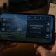 Realistic editorial image of a smartphone showing a muted social game chat interface next to a June calendar page marked 4 and a blurred Chinese moderation warning